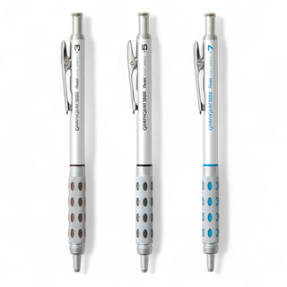 Three Pentel GraphGear metal mechanical pencils in a bundle laying flat on a white background - Shibuya Stationery