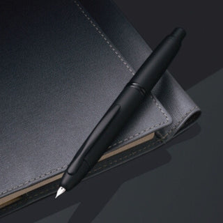 Pilot Vanishing Point Fountain Pen - Matte Black on notebook lifestyle - Shibuya Stationery