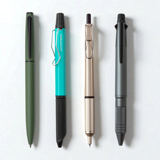 Four Mitsubishi Pencil brand Uni Jetstream series best selling pens in a row on a white background - Shibuya Stationery