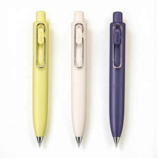 Three uni-ball one P 0.5mm tip gel pens pens in yellow, white, and purple displayed flat on a white background - Shibuya Stationery Store