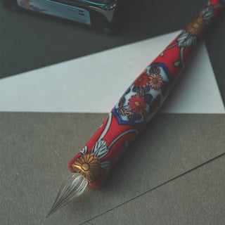 IMARIPEN Porcelain Glass Pen Gold Accent Red Floral placed on tabletop – Shibuya Stationery