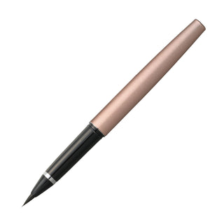 Pink gold Kuretake fountain brush pen laying diagonally with no cap on a white background - Shibuya Stationery Store