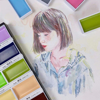 Watercolor painting of a person with the Kuretake gansai tambi nuance palette in the foreground - Shibuya Stationery Store