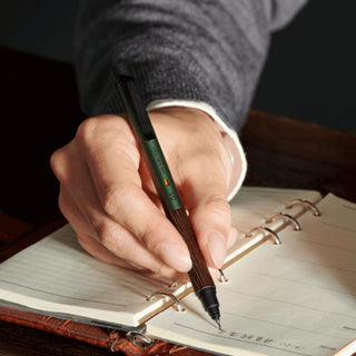Hand writing in a notebook with the Kuru Toga Wood mechanical pencil - Shibuya Stationery Store