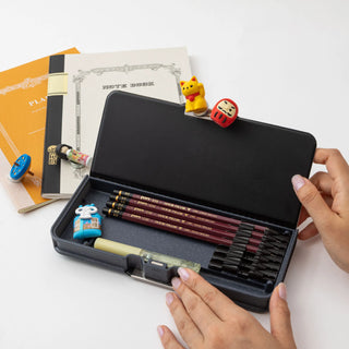Pittanton Magnetic Pencil Case Dinosaur in lifestyle scene being opened to show pencils – Shibuya Stationery