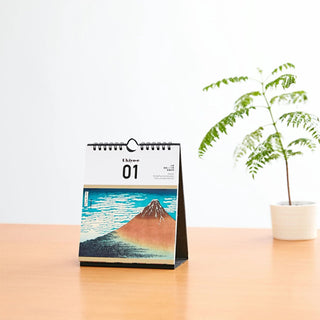 Ukiyo-e Daily Tear-Off Calendar 2026 desk display beside a plant – Shibuya Stationery