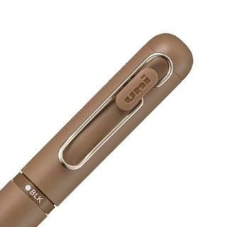 Close-up of the rear barrel selector mechanism on the Uni-ball One 3 in Sugar Brown for switching ink colors.