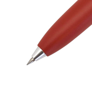 Close-up of the 0.5mm tip on the Uni-ball One 3 multi pen in Brick Red, showing the precision writing point.