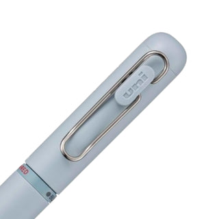 Detailed view of the rear barrel color selectors on the Uni-ball One 3 multi pen in Shirt Blue for switching between ink colors.