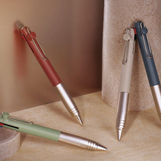 Four Uni-ball ZENTO Flow Model 3-color ballpoint pens in different colors standing together in a lifestyle setting - Shibuya Stationery Store