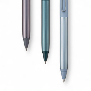 Three metallic Mitsubishi Pencil brand Japanese ballpoint pens in different colors on a white background - Shibuya Stationery Store