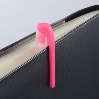 Pink Kuretake brand ZIG Brush High-Lite Quick C+ Highlighter cap on a black book with a white background - Shibuya Stationery Store